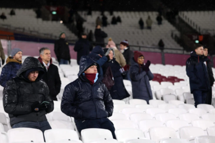 West Ham’s hierarchy have risked the wrath of supporters once again, serving up a cynical response to the single biggest issue tearing the club apart, insisting winning games is the only thing that’ll bring back the 30,000 fans who have walked away. It’s a decade this summer since the controversial switch from Upton Park to the London Stadium. And the proof that so many still ain’t buying it? A staggering 30,000 long standing Hammers, including former season ticket holders have simply stopped going. You’d think that figure, enough to fill a decent sized ground on its own, would have alarm bells ringing in the boardroom. Instead, the message back from the top is brutally short sighted: win more matches, and they’ll come flooding back. The details emerged from the latest Fan Advisory Board meeting, where vice chair Karren Brady was pressed on the deepening disconnect. For years now, supporters have pointed to a cocktail of problems, the soulless stadium, the ticket prices, the atmosphere, the growing sense the club’s soul was left behind in the East End. But when the board was asked what they plan to do to win back the thousands who’ve voted with their feet, the response was as blunt as it was revealing. According to the minutes published by the West Ham United Independent Supporters’ Committee, the club said “winning matches is the only thing that matters in encouraging supporters to return”. Let that sink in. After a decade of fractured relationships, protests, and surveys piling up with evidence that fans are crying out for engagement, pricing reform and a stadium experience that doesn’t feel like a rented athletics venue, the answer is just… win. Of course, no one’s daft enough to pretend results don’t matter. A winning team lifts the place. We’ve seen it in recent months as Nuno Espirito Santo’s side has turned a corner. The buzz returns. The turnstiles spin a bit quicker. But to suggest winning is the only thing? That’s either delusional or deliberately dismissive. Possibly both. Because here’s the thing: thousands walked away before a single ball was even kicked at the London Stadium. They saw the move for what it was, a trade off that swapped the intimacy, identity and raw soul of Upton Park for a running track and corporate boxes. Results didn’t come into it. Not then, not now. The supporters’ committee didn’t mince words in their report, pointing out that fans cite “multiple reasons for disengagement, all backed up by surveys, including: ticket prices, stadium experience, atmosphere, wider club culture”. They added: “The club currently sees on pitch performance as the primary solution to declining attendance.” And when the board was pushed on whether there’s a wider plan to address the likes of pricing, atmosphere and stadium design? Apparently, there wasn’t one offered. No review of ticket structures. No roadmap to fix the disjointed atmosphere. No acknowledgment that for many, the London Stadium still feels like a temporary home, a decade on. It’s a staggering blind spot or perhaps it ain’t a blind spot at all. Perhaps it’s a sign that David Sullivan, Daniel Kretinsky and the rest genuinely believe results alone can paper over the cracks. The irony is thick enough to choke on. This was meant to be the grand vision, a shiny new home to propel West Ham into a new era. Instead, you’ve got 30,000 former regulars staying away, empty seats telling their own story, and a fanbase that feels more disenfranchised than ever. Winning helps. It always does. But it ain’t a magic wand. Trust, connection, a sense that supporters are being listened to, those are the things that bring people back and, more importantly, keep them coming. Right now, that’s what’s missing. And until the board wakes up to that reality, the disconnect will only get wider. The Hammers are showing signs of life on the pitch. Off it? The same old problems remain and this latest response suggests the people in charge still don’t have a clue what the real issue is.